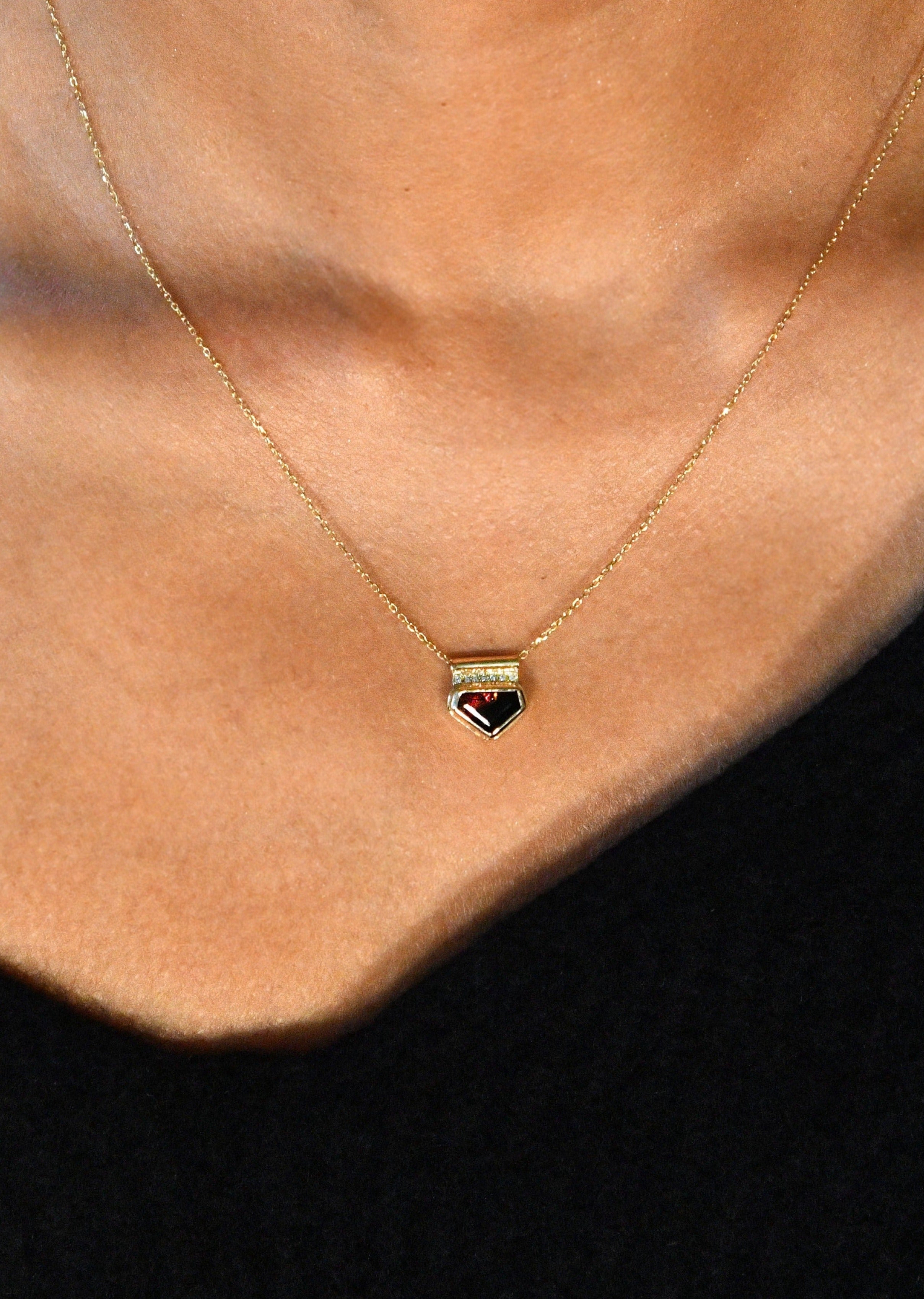 Minimalist black tourmaline pendant with pavé diamonds on a gold charm necklace