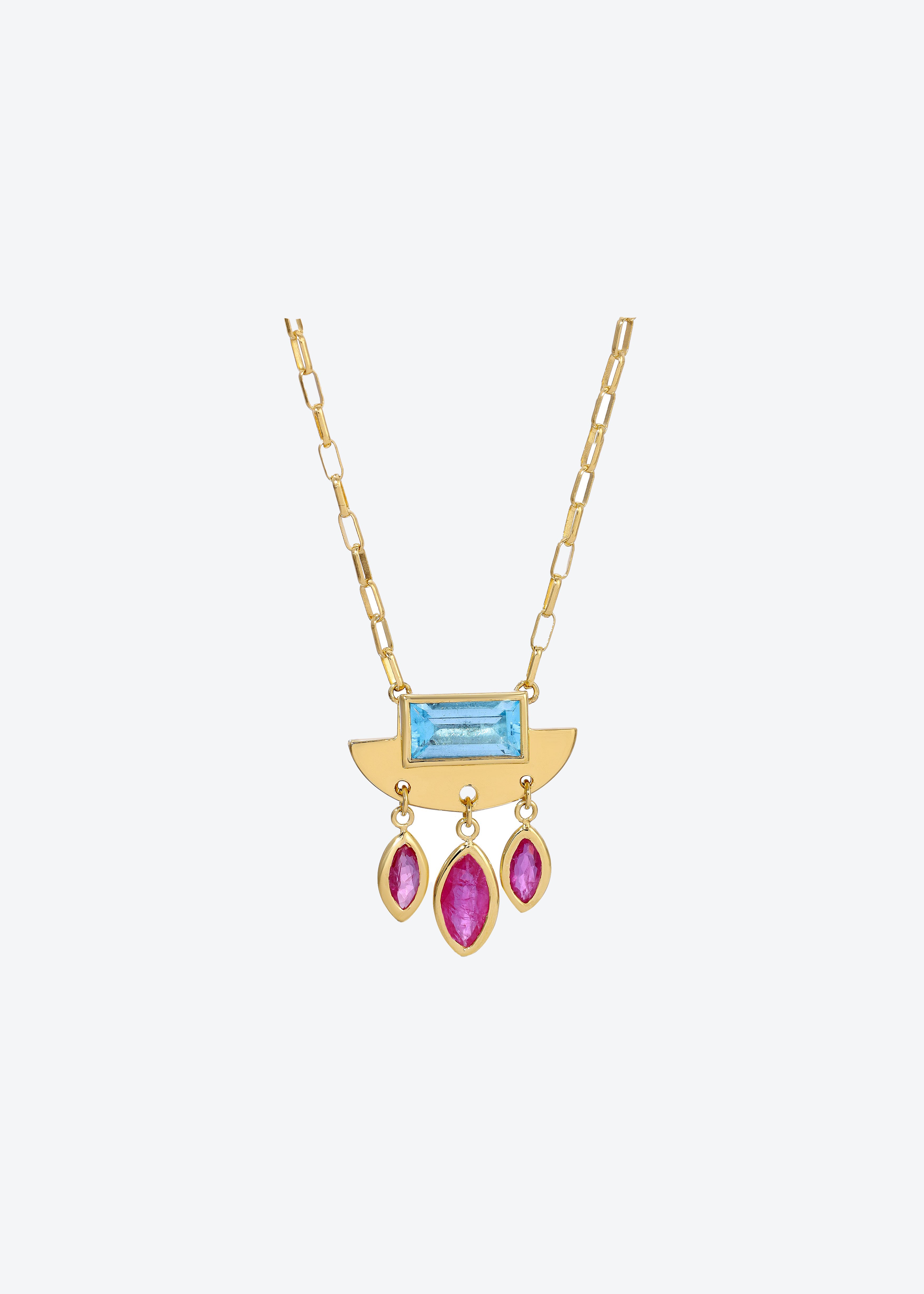 Gold crescent pendant with dangling ruby charms and blue topaz centerpiece