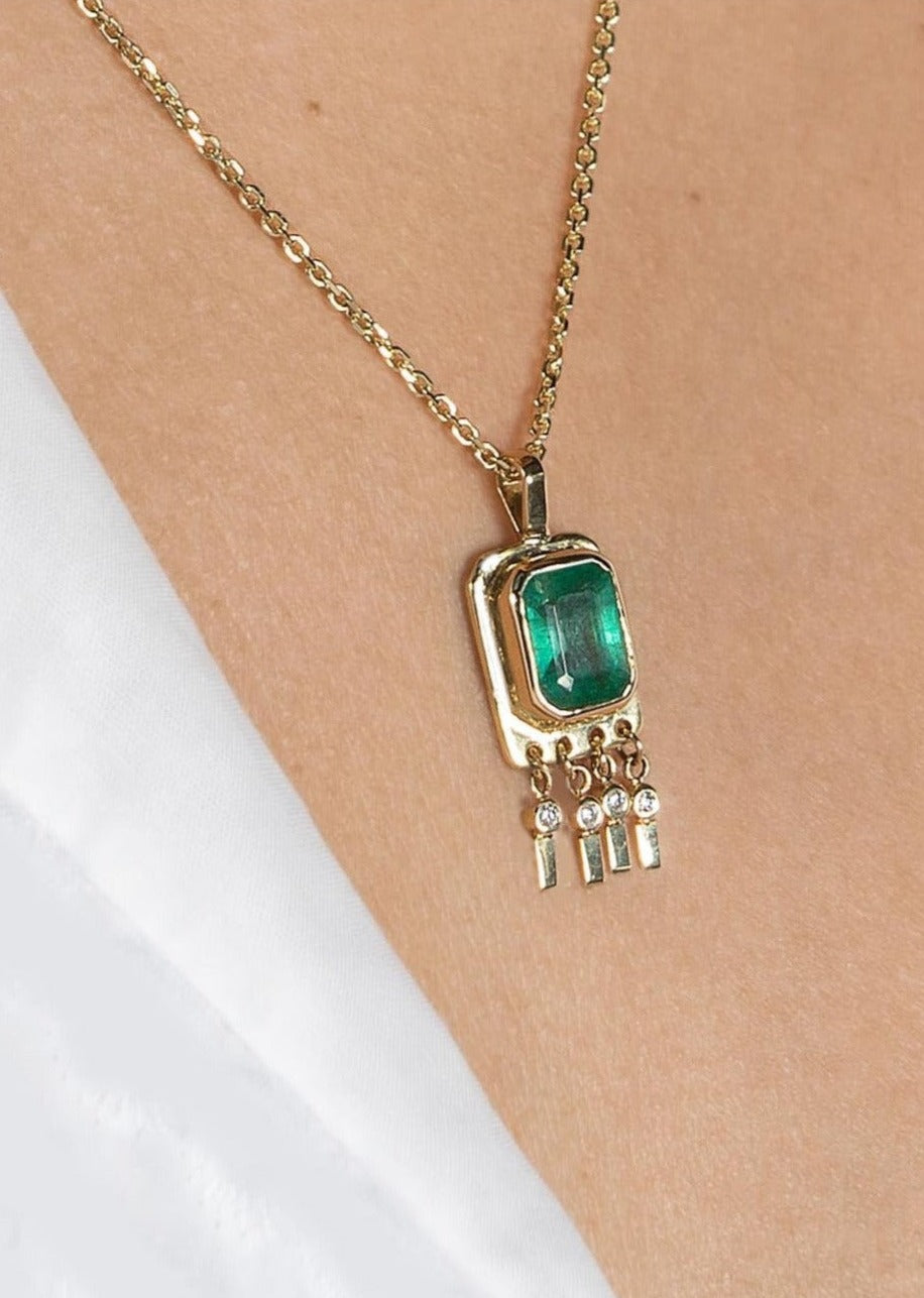 Bezel-set emerald necklace with diamonds dangles in solid 14K yellow gold, designed for layering or solo wear as a statement piece