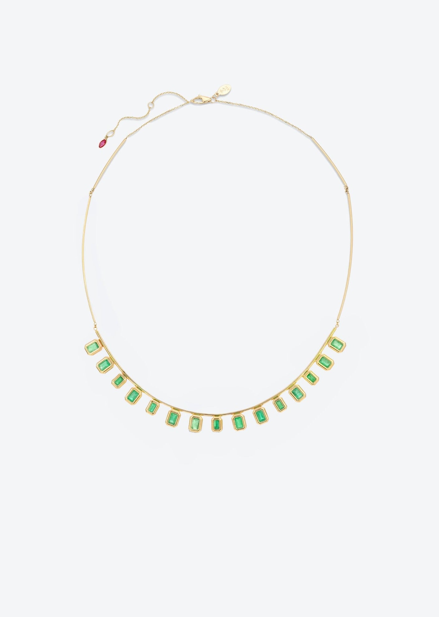 Emerald minimalist collar necklace crafted in 14K gold with a pink ruby drop detail, designed as a bold statement piece for formal occasions.