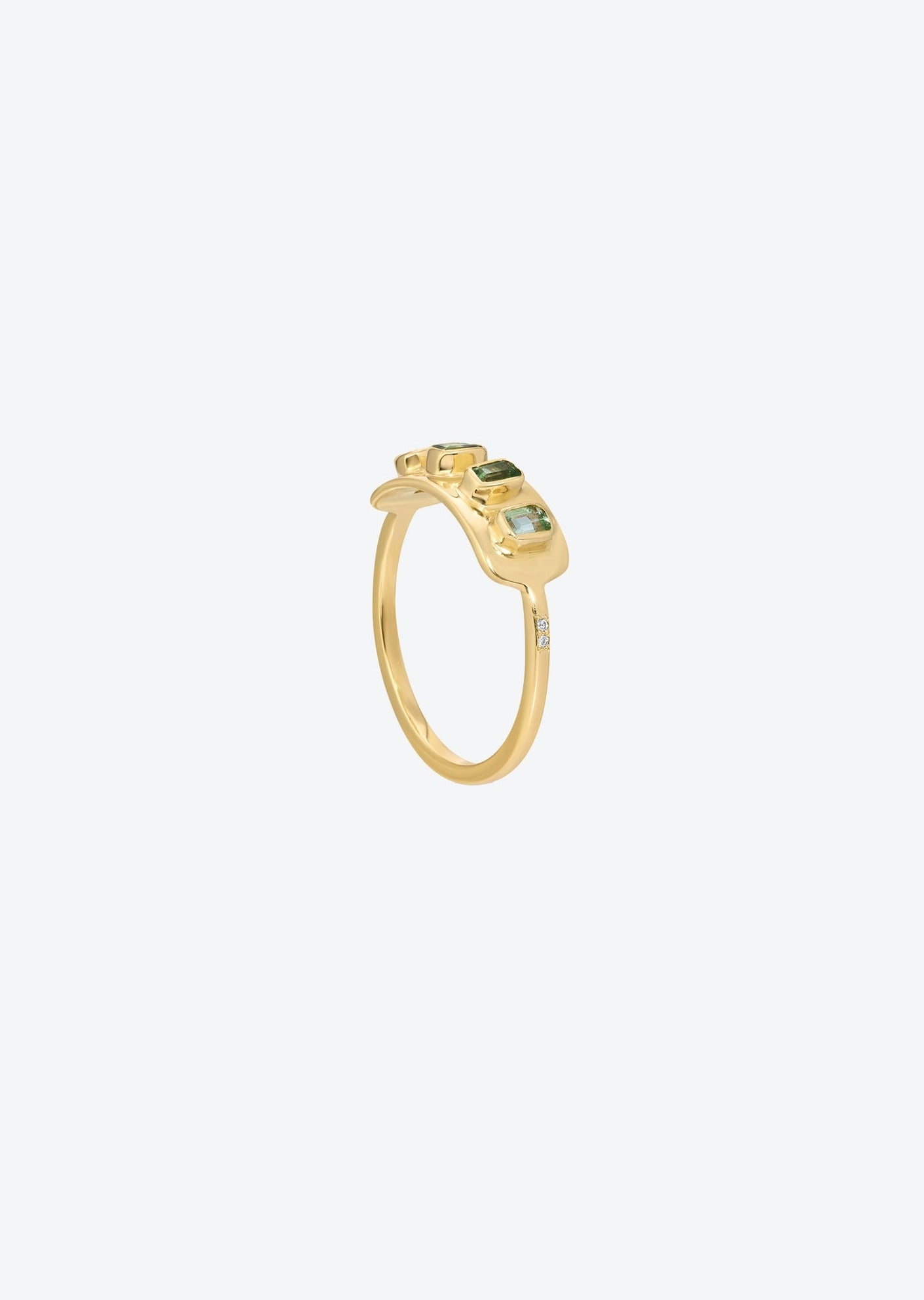 Green tourmaline sun ring featuring radiant-cut gemstones and pave diamonds on a 14K gold band