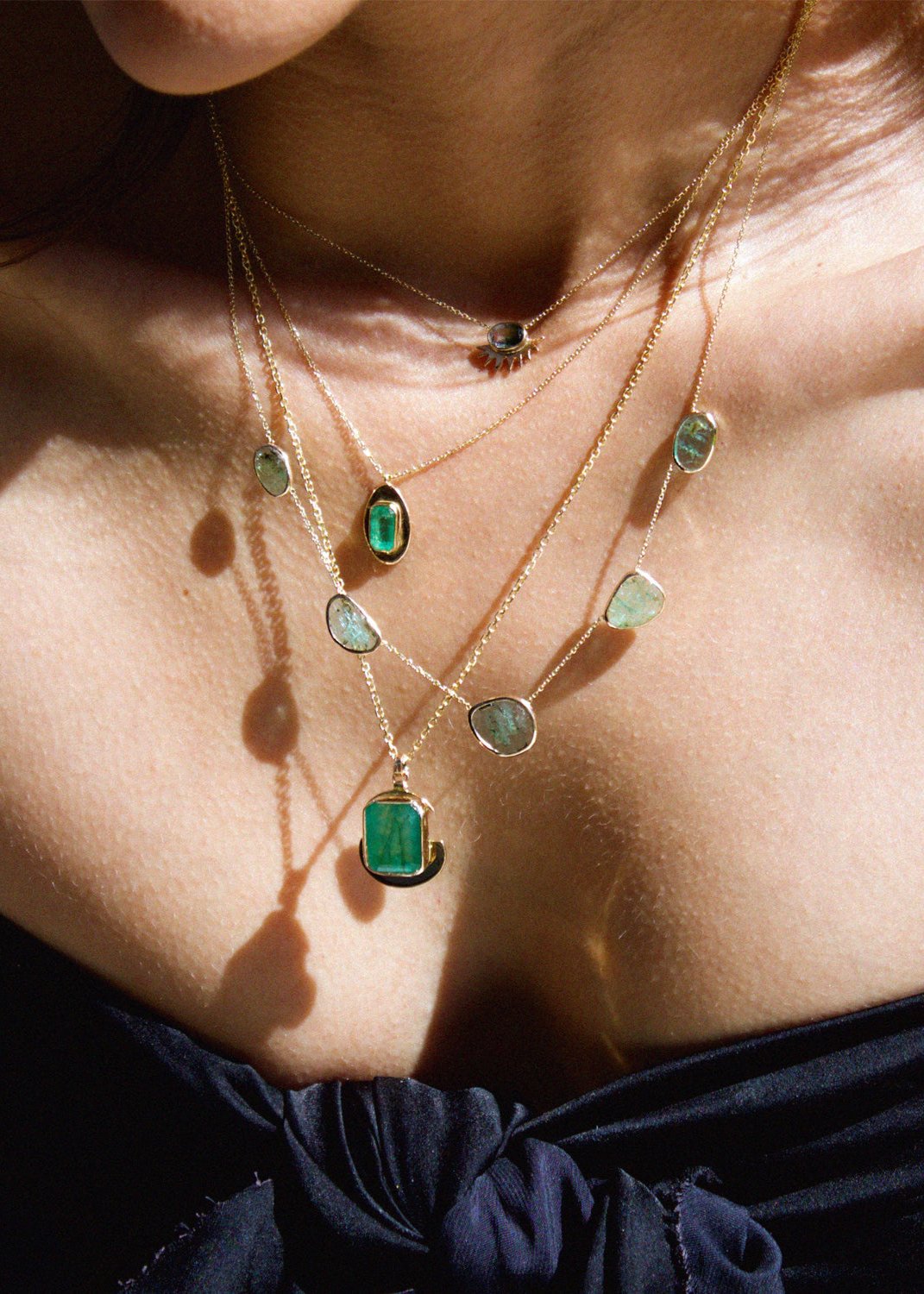 emerald station necklace with five blue green emeralds on a dainty 14k gold chain