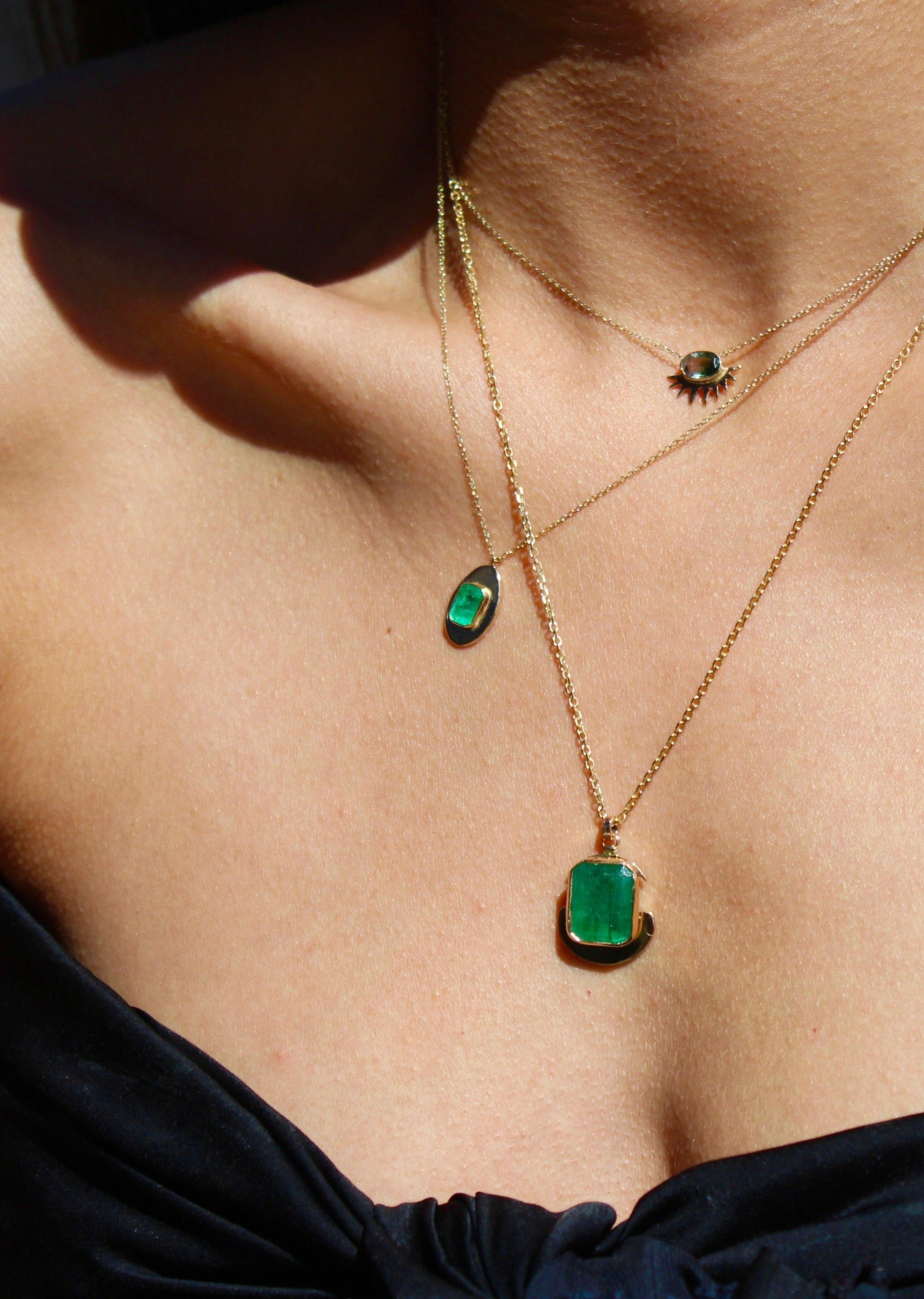 Gold statement charm pendant necklace with May’s birthstone in an egg-inspired design, perfect for casual or formal wear