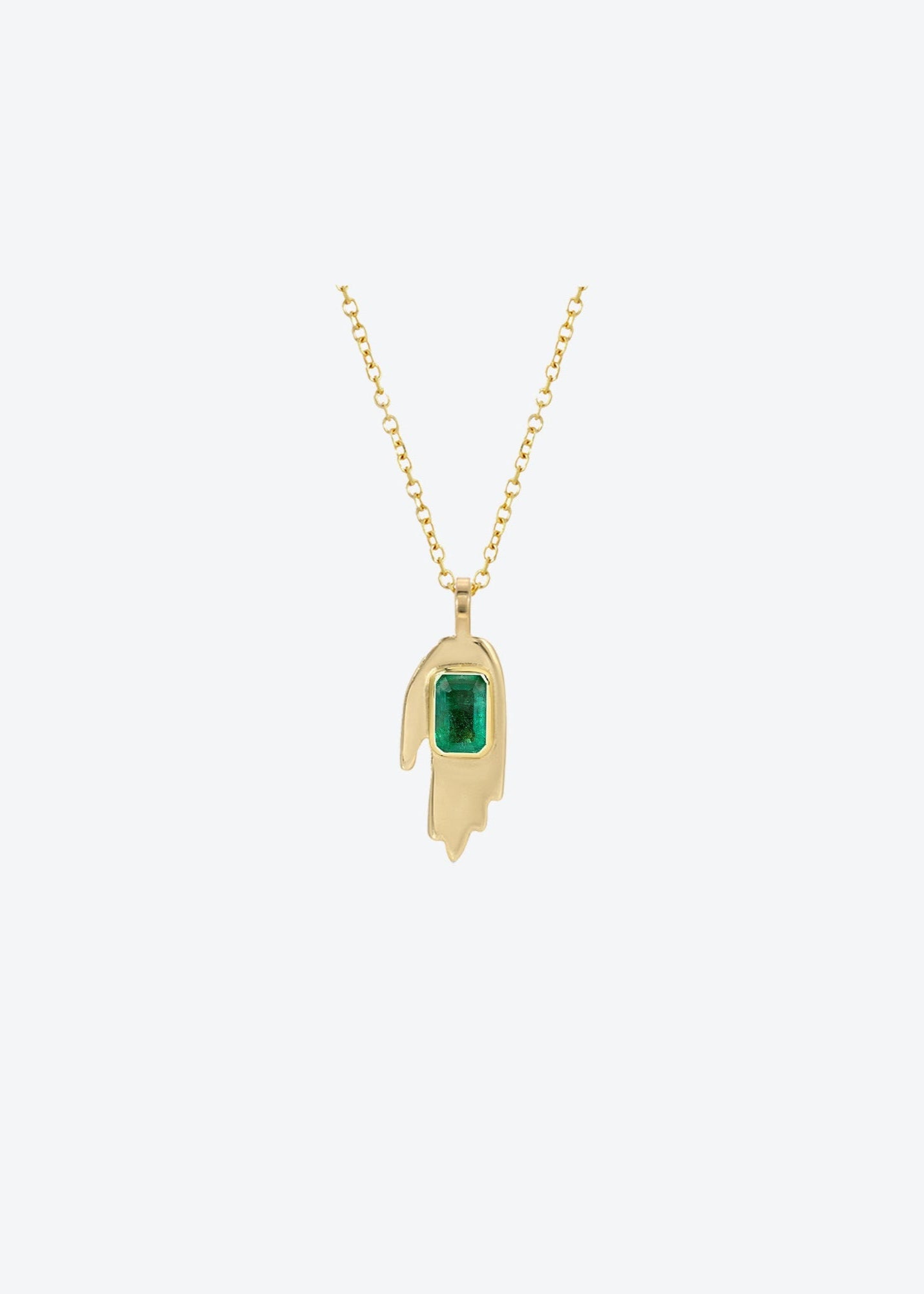 Hamsa hand-inspired gold pendant featuring emerald-cut emerald on cable chain