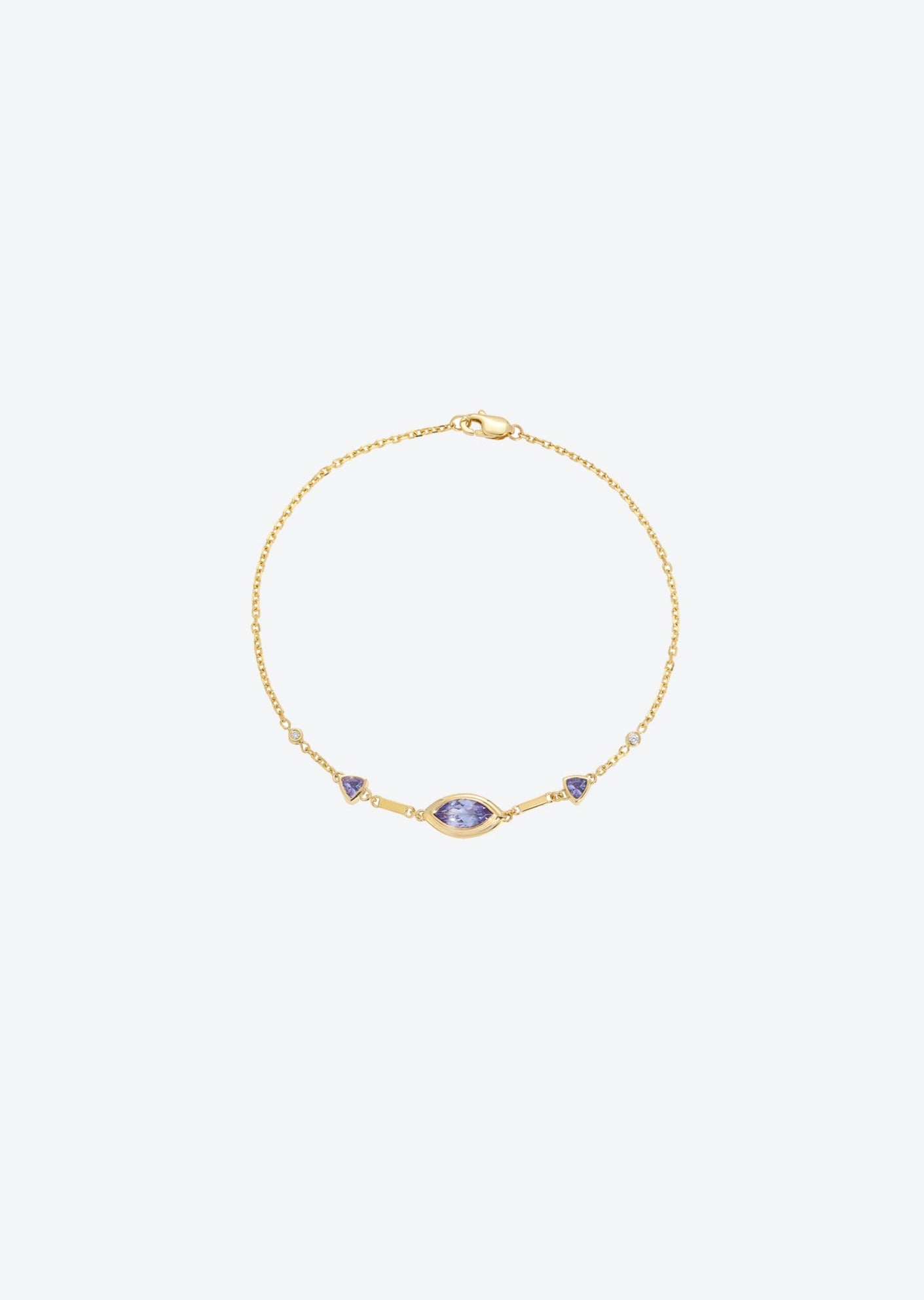 Gold chain bracelet featuring tanzanite stones and diamond details, designed for versatile wear as a dainty accessory